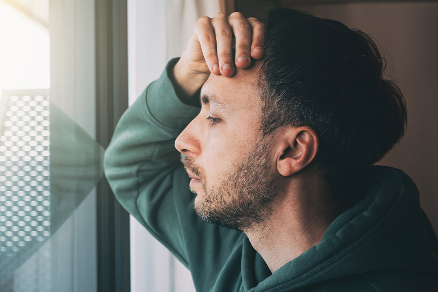 a man thinking and looking out the window